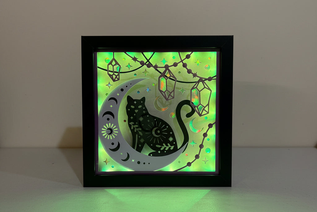 Decorative light box with a cat design on a wall