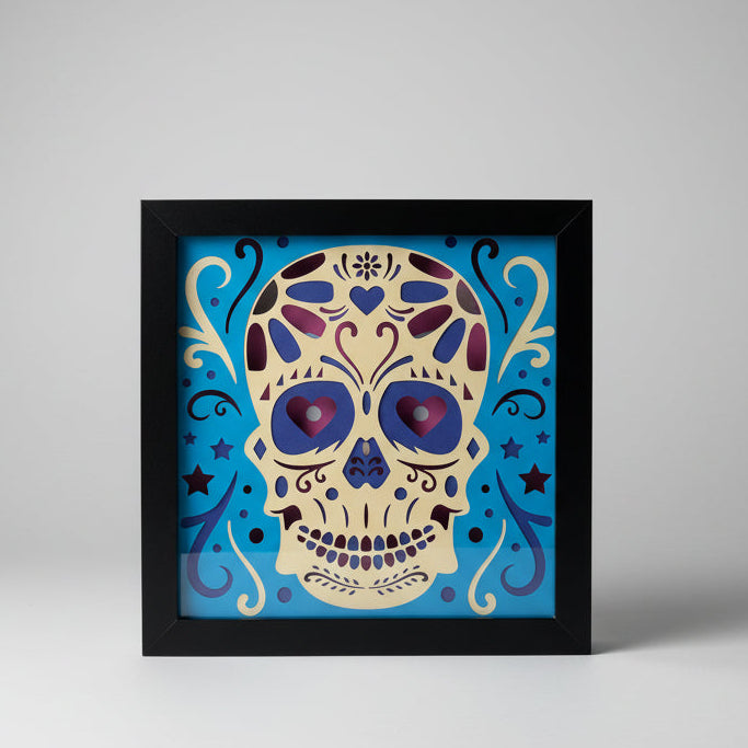 Decorative skull artwork with blue and purple accents in a black frame.