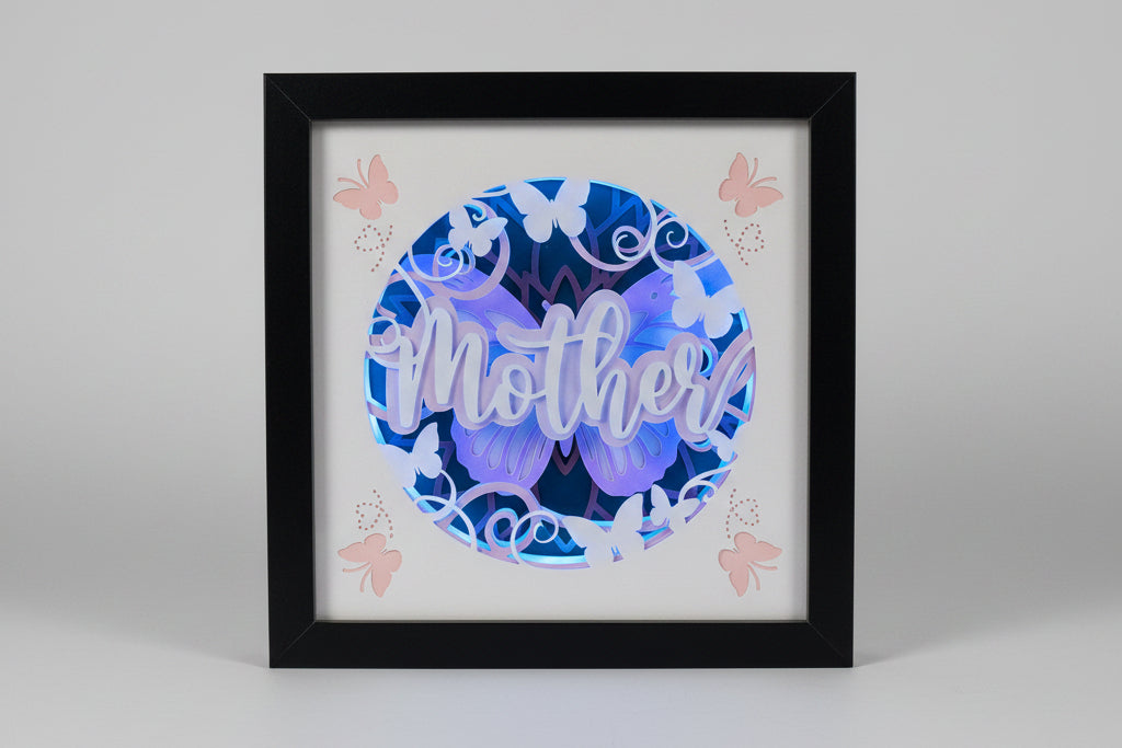 Framed decorative wall art with butterfly designs and the word 'Mother' on a light background.