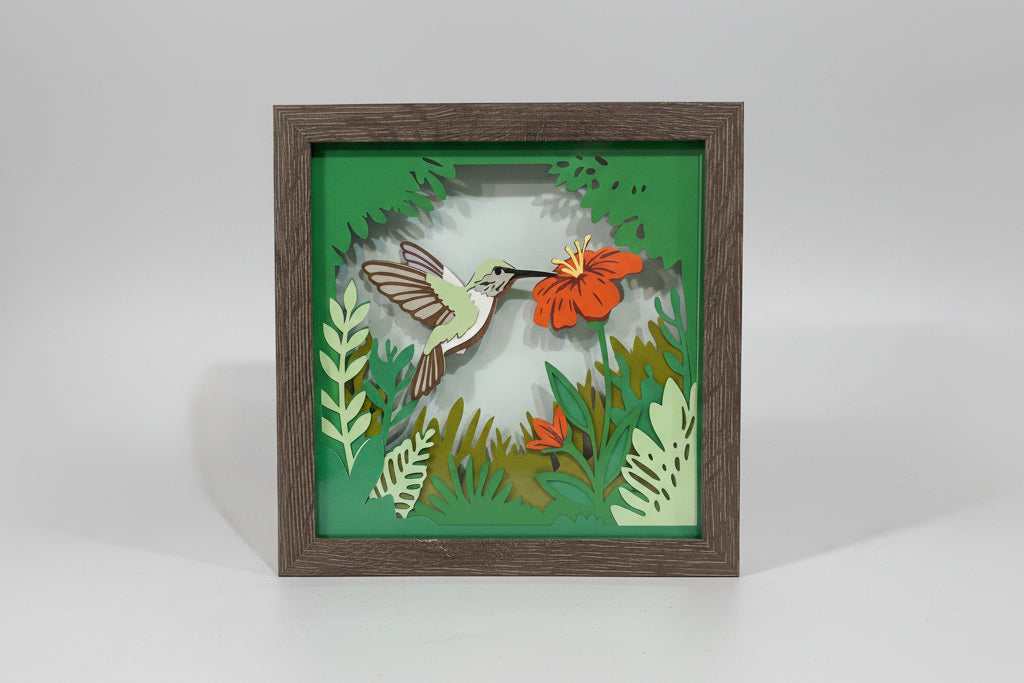 Framed artwork of a bird and flowers on a wall